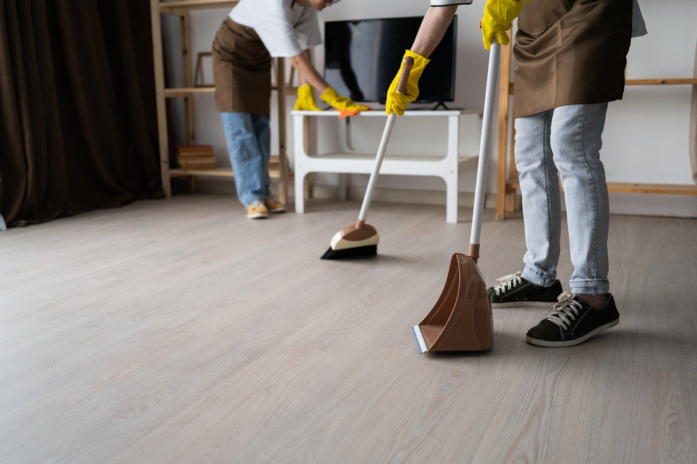 Two cleaners are conducting a deep clean on a rental property.