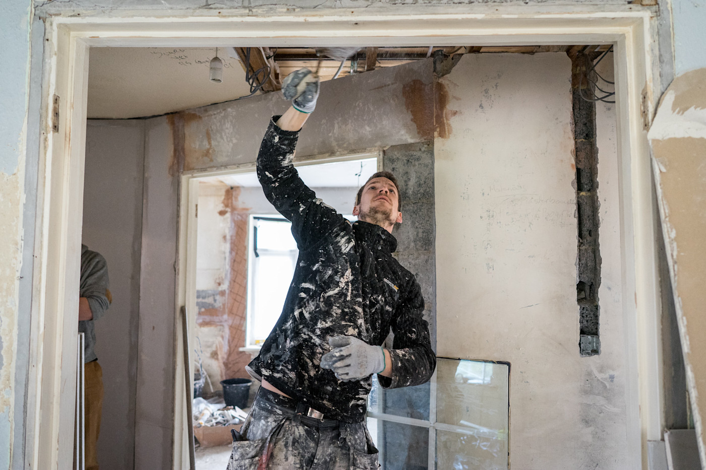 A builder working on renovating a living room
