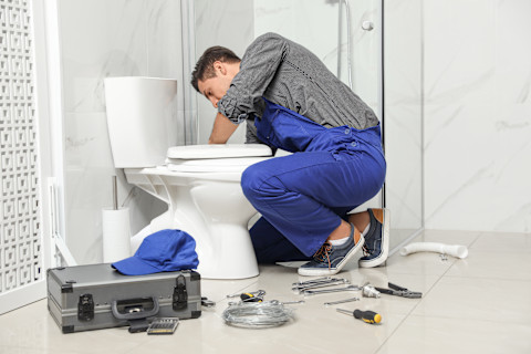 plumber-installing-toilet