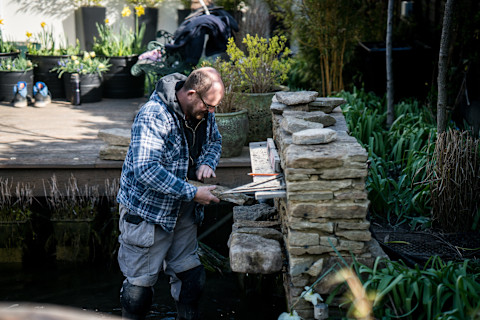 A landscaper working in a garden