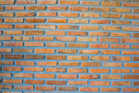 Brick brown wall with cement mortar.