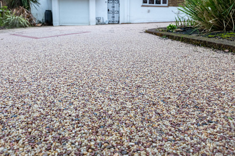 Resin driveway leading up to a large residential property
