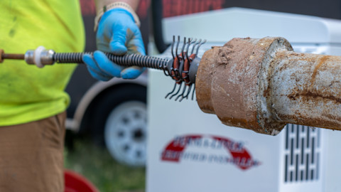 A tradesperson is carrying out a drain relining job