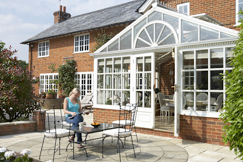 Exterior Of House With Conservatory And Patio.
