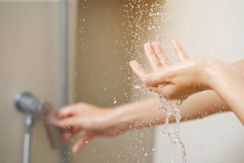 Checking shower water temperature