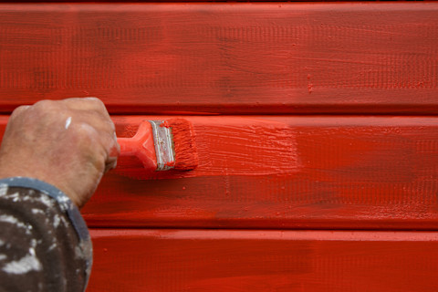 handyman-painting-red-garage-door