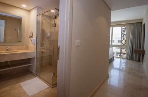 Interior design decor furnishing of luxury show home bedroom showing furniture and double bed with en suite bathroom