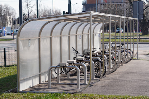 Cycles parked in a cycle shelter.