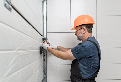 Man installing Garage insulation 
