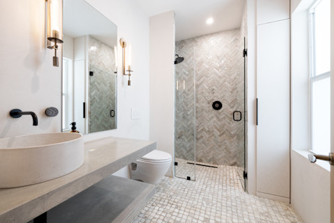 Clean, modern bathroom with refreshing shower, reflecting mirror, Bathtub and sleek tiles.