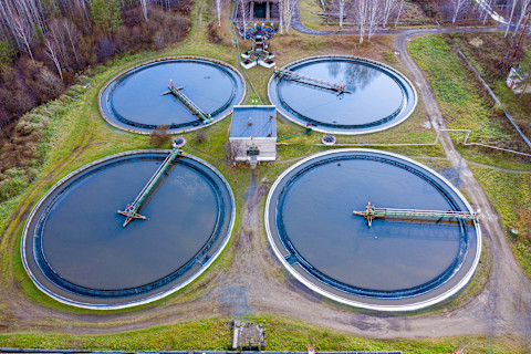 A greywater system setup, including pipes and tanks, used for recycling and reusing wastewater from sinks and showers, installed in a residential or commercial setting.