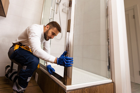 Man installing a shower tray