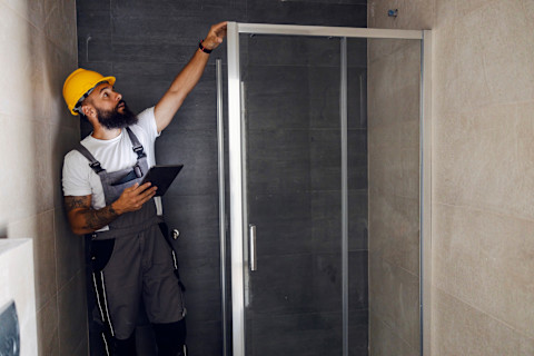 A plumber installing a digital shower.