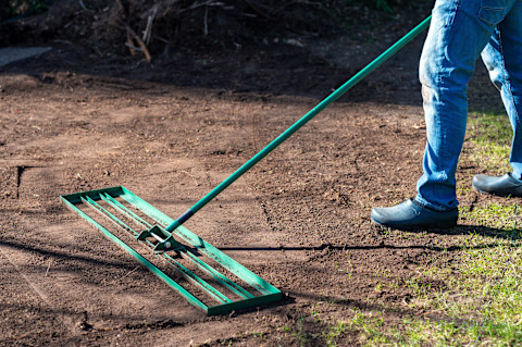 A man is levelling a new garden