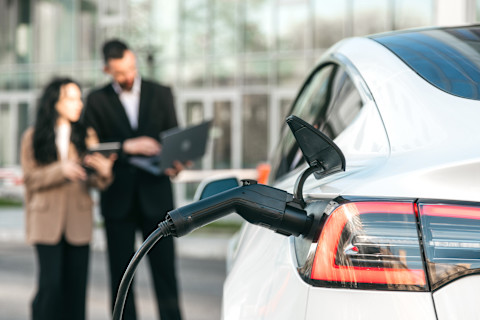 A man is talking through EV charger installation grants