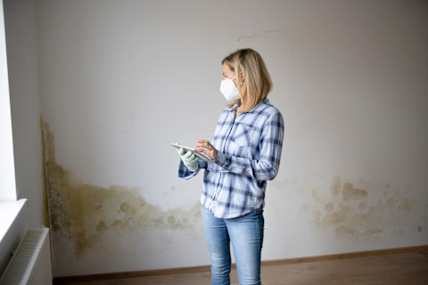woman-looking-at-damp-walls