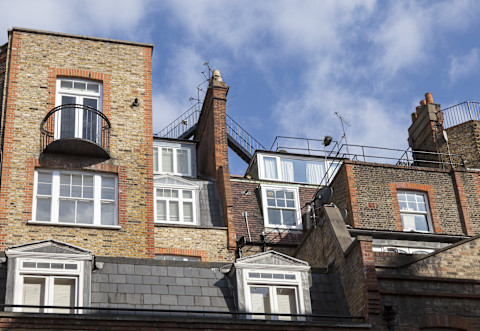 An ornate iron balcony with intricate railings, extending from a building’s exterior, offering a stylish and classic architectural feature.