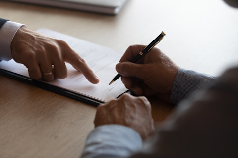 People signing some lease extension papers.