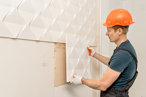 Wooden wall panels are being installed.