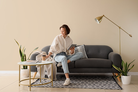 Woman sitting on a reupholstered sofa