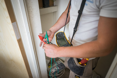 An electrician with his tools testing potable appliances
