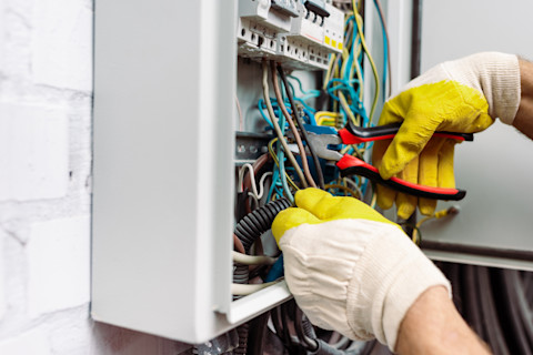 Electrician working on electrical circuit installation.