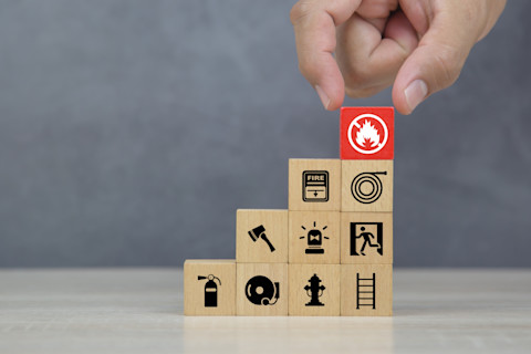 A stack of wooden blocks with images of fire fighting symbols and equipment