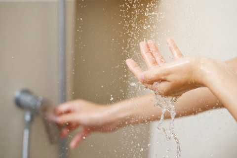 Checking shower water temperature