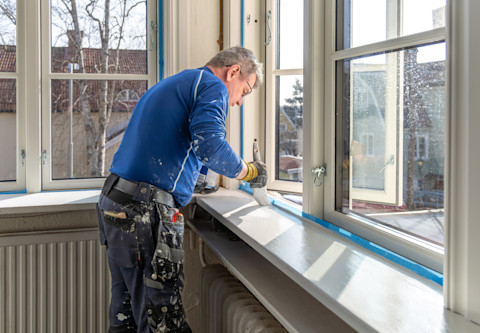 A handyman is doing some property maintenance around the home.