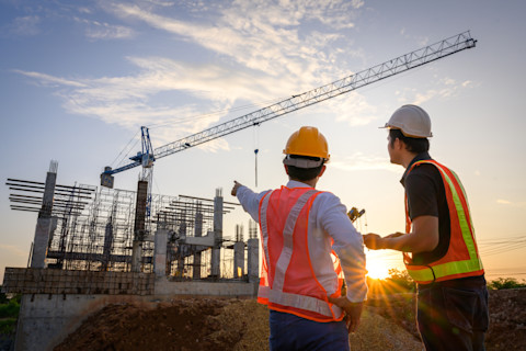 Builders pointing at a construction zone analysing the structure