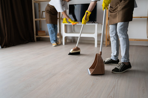 Two cleaners are conducting a deep clean on a rental property.
