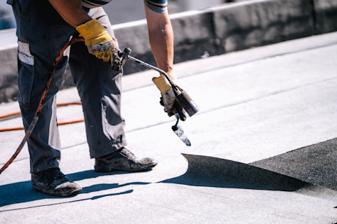 Man installing Flat Roof Insulation