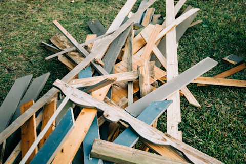 A large pile of scrap wood from a demolished shed during the demolition process.