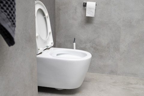 A macerator toilet in a grey-themed bathroom