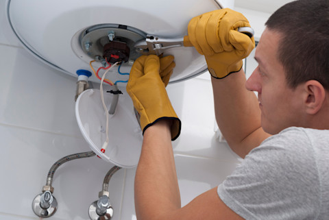 A man is replacing a boiler in the UK.