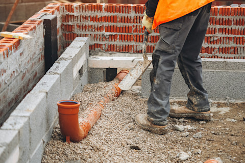A tradesperson is installing new driveway drainage system