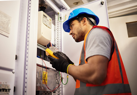 Electrician checking electric meter