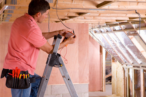 A tradesperson is working on a loft conversion