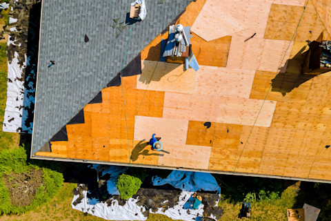 Roof repair by replacing old asphalt bitumen shingles.