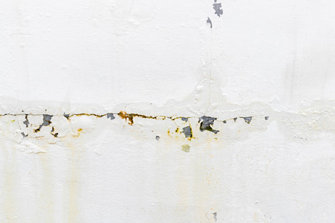 Water seeping through the wall due to rain showing signs of water damage.