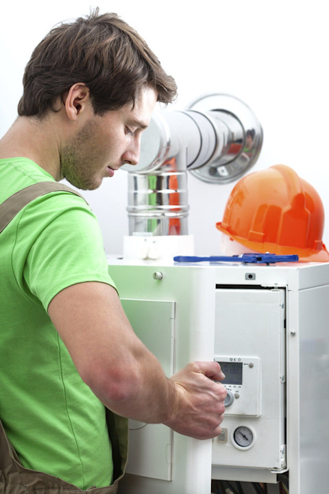 A man is fitting a new boiler.