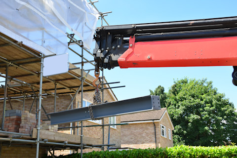 A crane lifting a girder into position.
