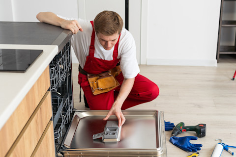 man fixing dishwasher