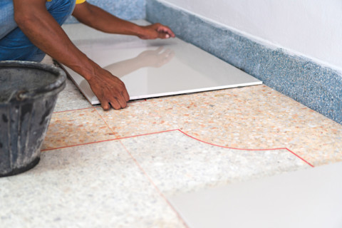 person-laying-tile-on-tile