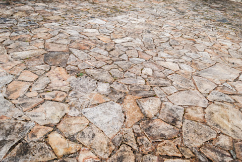 Crazy paving design on a driveway and patio, featuring irregularly shaped stones in various colors.