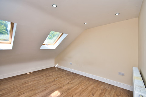 An attic room with white walls.