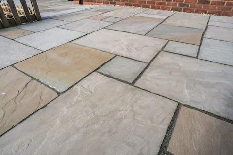 This image shows a close up large rectangular stone patio slabs.