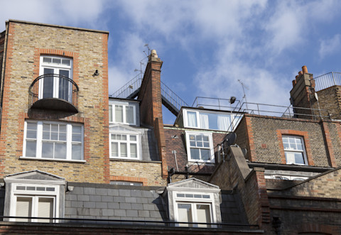 An ornate iron balcony with intricate railings, extending from a building’s exterior, offering a stylish and classic architectural feature.