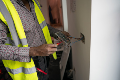 An electrician installing a smart plug.