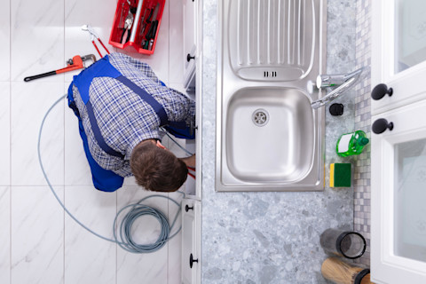 plumber-fixing-sink